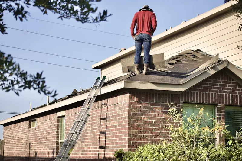 Professional roofer working on a residential roof in New River